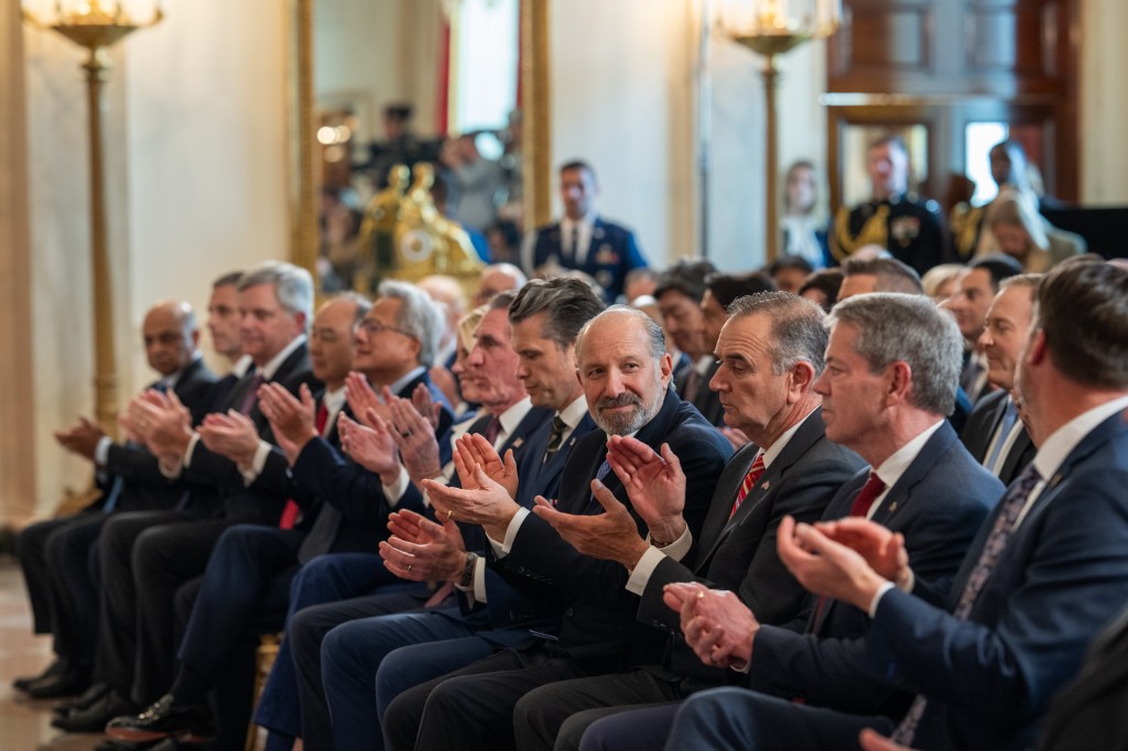 Secretary of Commerce Howard Lutnick and other members of President Donald Trump’s Cabinet clap before his remarks on “Investing in America”, Wednesday, April 30, 2025, in the Cross Hall of the White House. (Official White House Photo by Molly Riley)